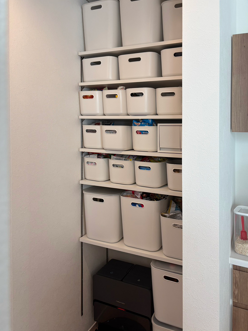 白い収納ボックスが整然と並ぶパントリー棚